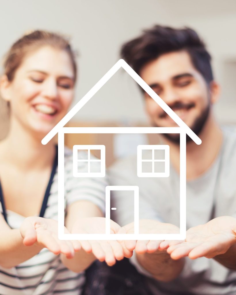 Young couple holding their new, dream home in hands